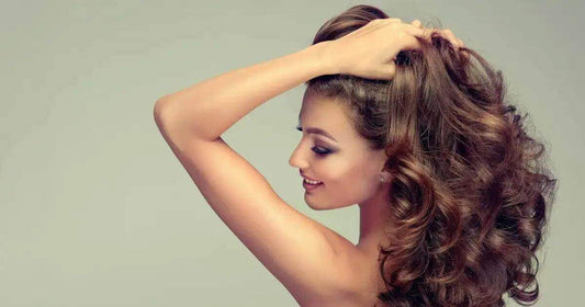 Woman showcasing healthy hair benefits of Shea Moisture Shampoo with beautiful curls.